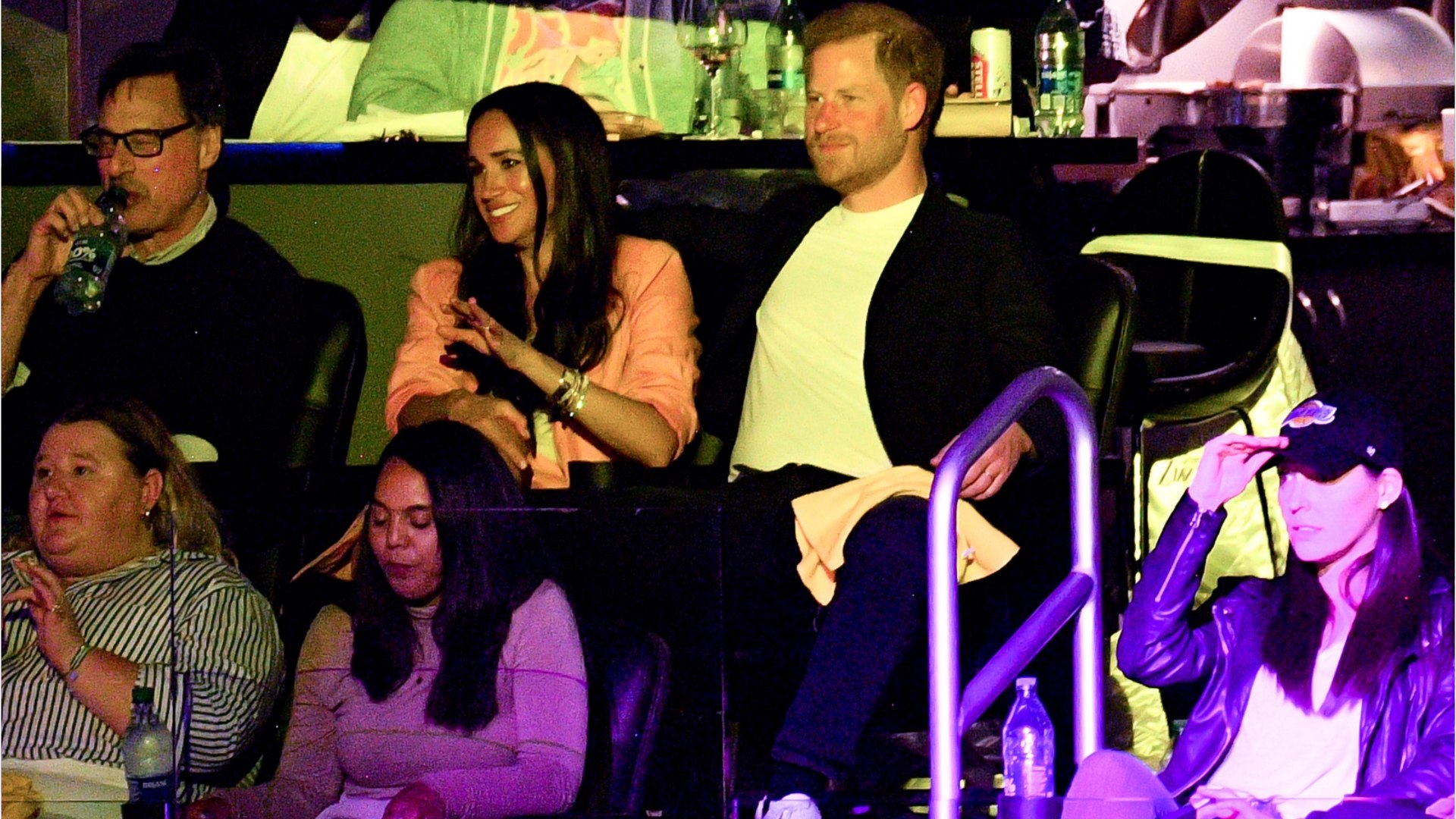⁣Prince Harry and Meghan Markle share a sweet 'kiss cam' moment at basketball game