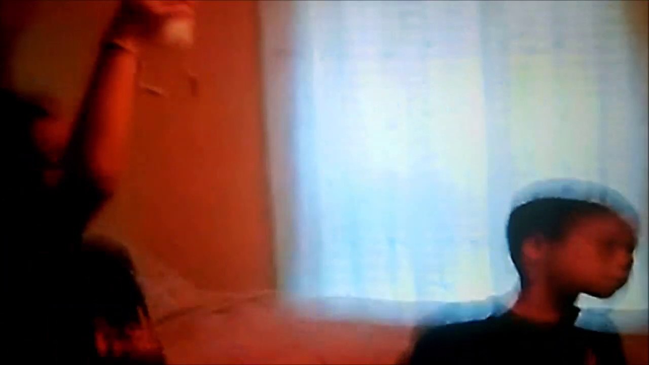 Jonathan playing the wii while Christopher & Anthony watch