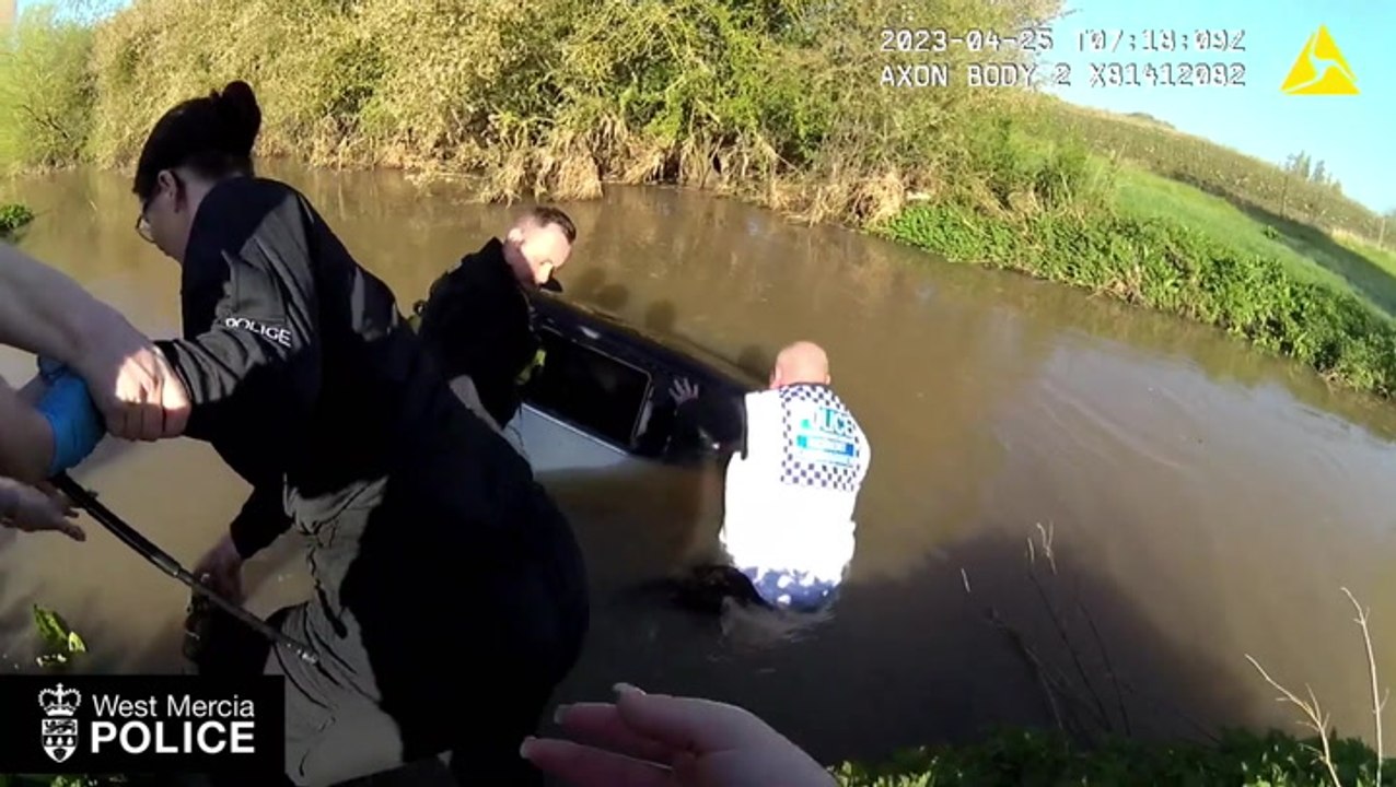 Dramatic moment woman trapped in sinking car saved as police form human chain