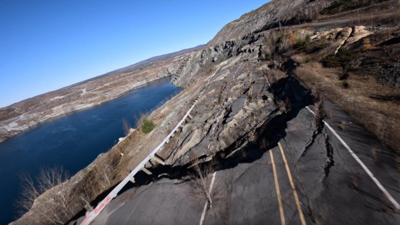 Aerial Drone Shot of a road ruined and taken over by Mother Nature