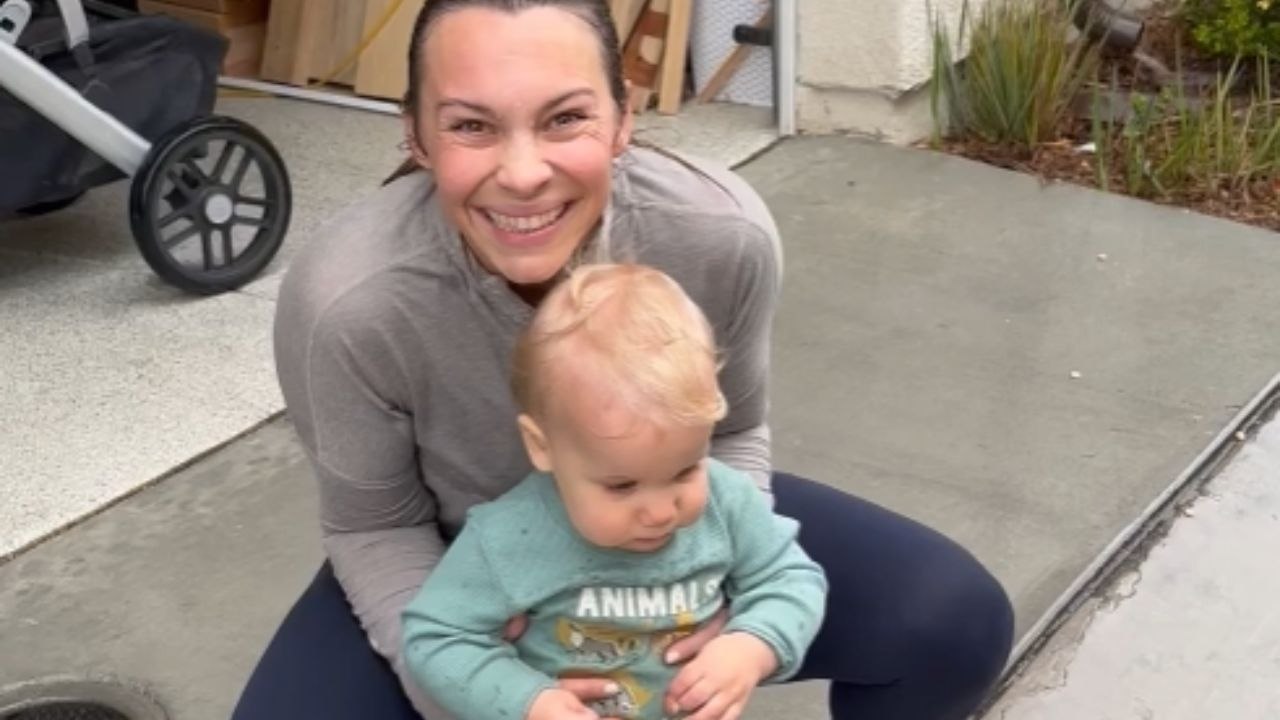 Mom helping baby boy unlock his ability to jump in the rain