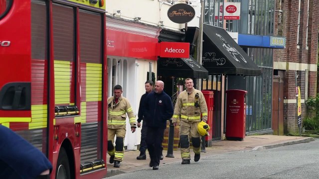 Fire fighters remain at the scene of last night's fire on Mount Street, Preston