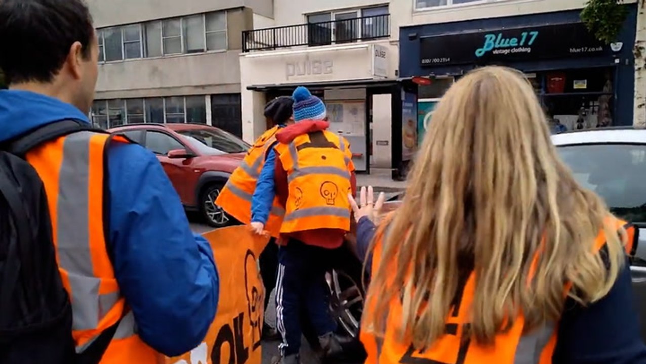 Moment motorist drives through Just Stop Oil protesters blocking road