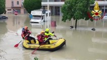 Firefighters row through submerged streets as Italy floods kill at least two