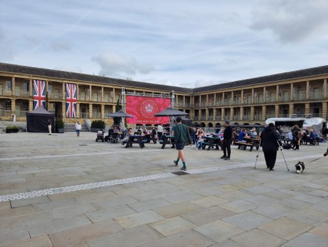 Patriotic spectators watching the Coronation live on the big screen at the Piece Hall