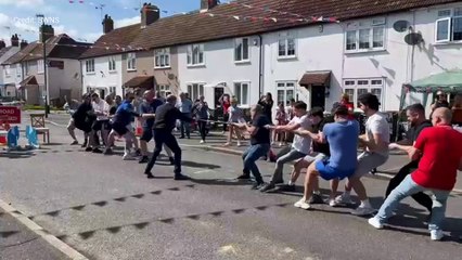 Rope snap during street party tug of war
