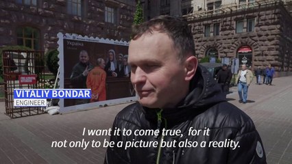 A new stamp-style installation in Kyiv illustrates Putin in court