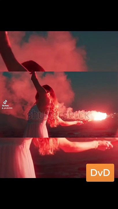 woman waving red flare dancing on beach at dawn expression creative freedom burning distress signal firework
