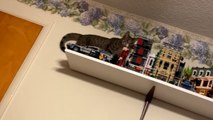 Mischievous cat wrecks havoc on the Legos by knocking them over the shelf