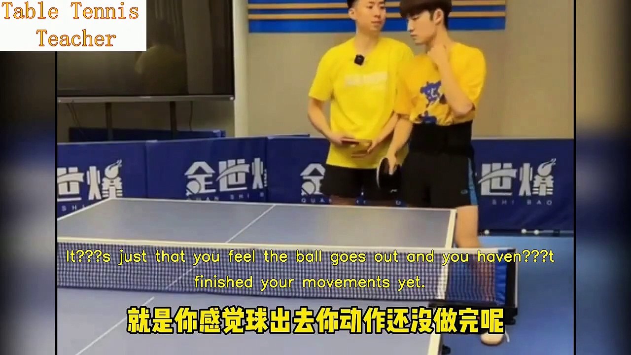 Fang Bo teaches student proper technique for backhand loop drive