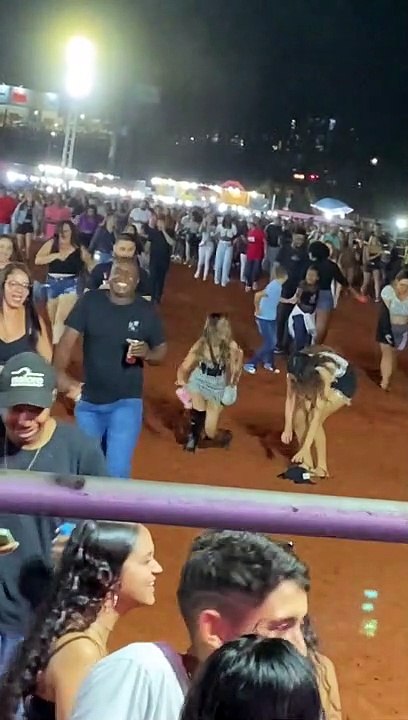 Woman Trips While Running With Crowd