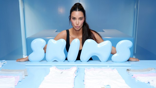 Kim Kardashian Accessorized a Plunging Zip-Up Bodysuit With Sweatpants and Sneaky Pink Thigh-High Boots