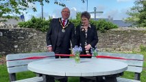 Cllr David Meredith and Joan Brown open a dementia friendly bench in Brecon