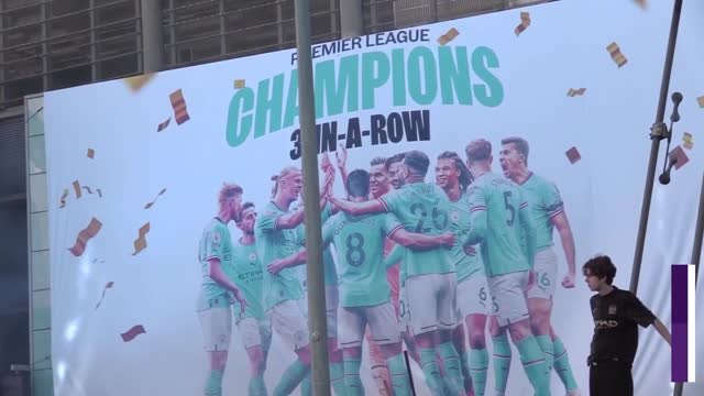 Manchester City fans celebrate winning the Premier League outside the Etihad