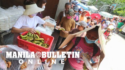 Street dwellers receive free food outside a church in Manila