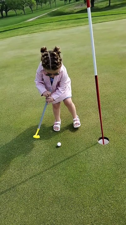 Girl Struggles to Putt