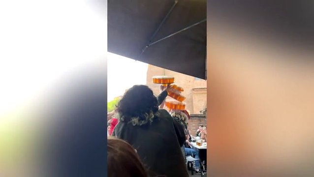 Hundreds of pints go flying as waiter tries his luck serving eight trays of beer