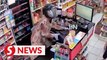 Police hunting convenience store robber dressed in baju kurung