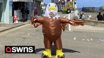 Seaside chippy worker scares off seagulls in an eagle outfit - so customers can eat their food in peace