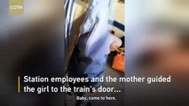 Girl falls between platform and train at Beijing Railway Station while mom glued to phone