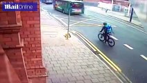 Shocking moment groggy cyclist stumbles into moving bus after falling off bike