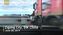 Woman riding a scooter narrowly survives being run over by a truck