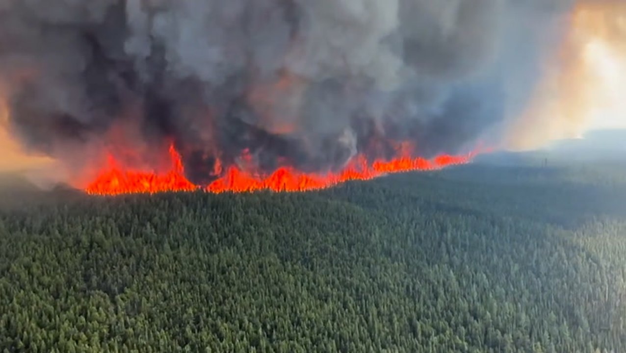 Helicopter flies past raging wildfire as Canada blaze rips through forest