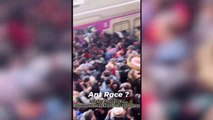 Hundreds of commuters in India packed onto a platform trying to board a train