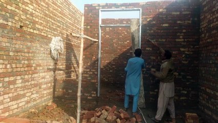 mason making a front house design