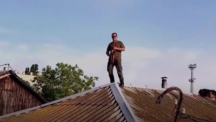 Saxophonist plays on rooftops of flooded Kherson homes