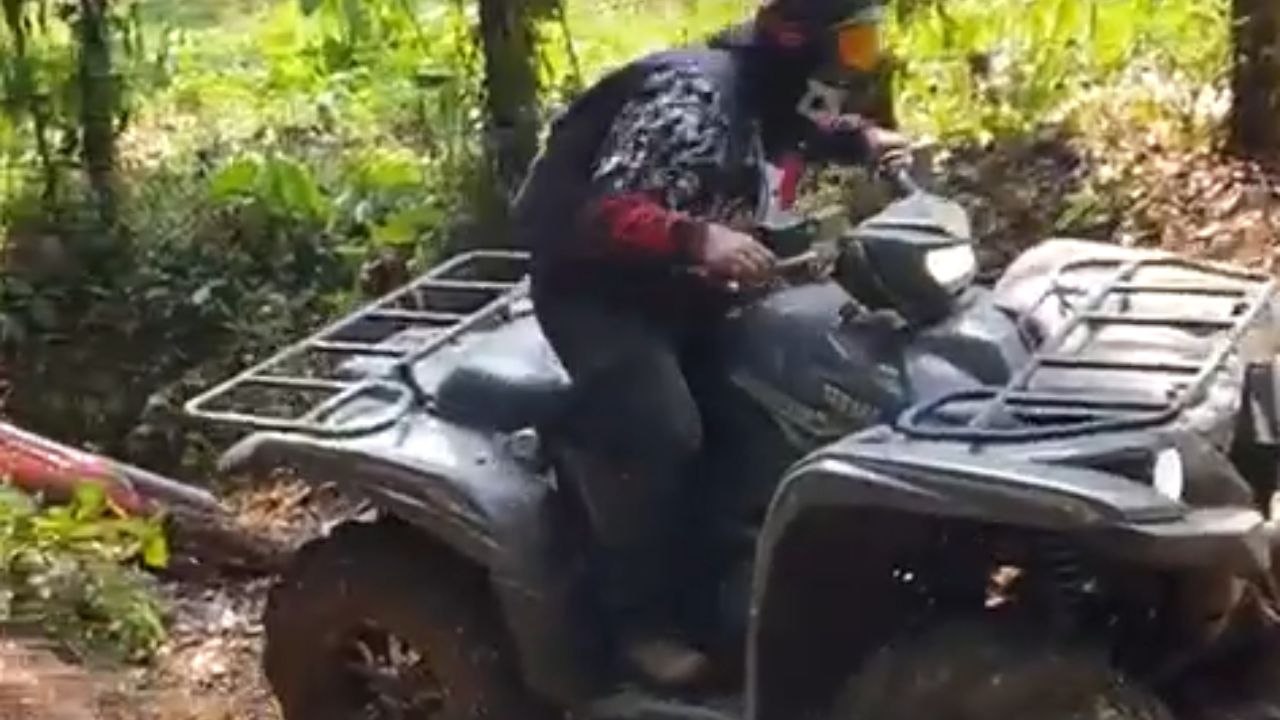 Man Driving Quad Dirt Bike crashes it backwards trying to climb a steep path