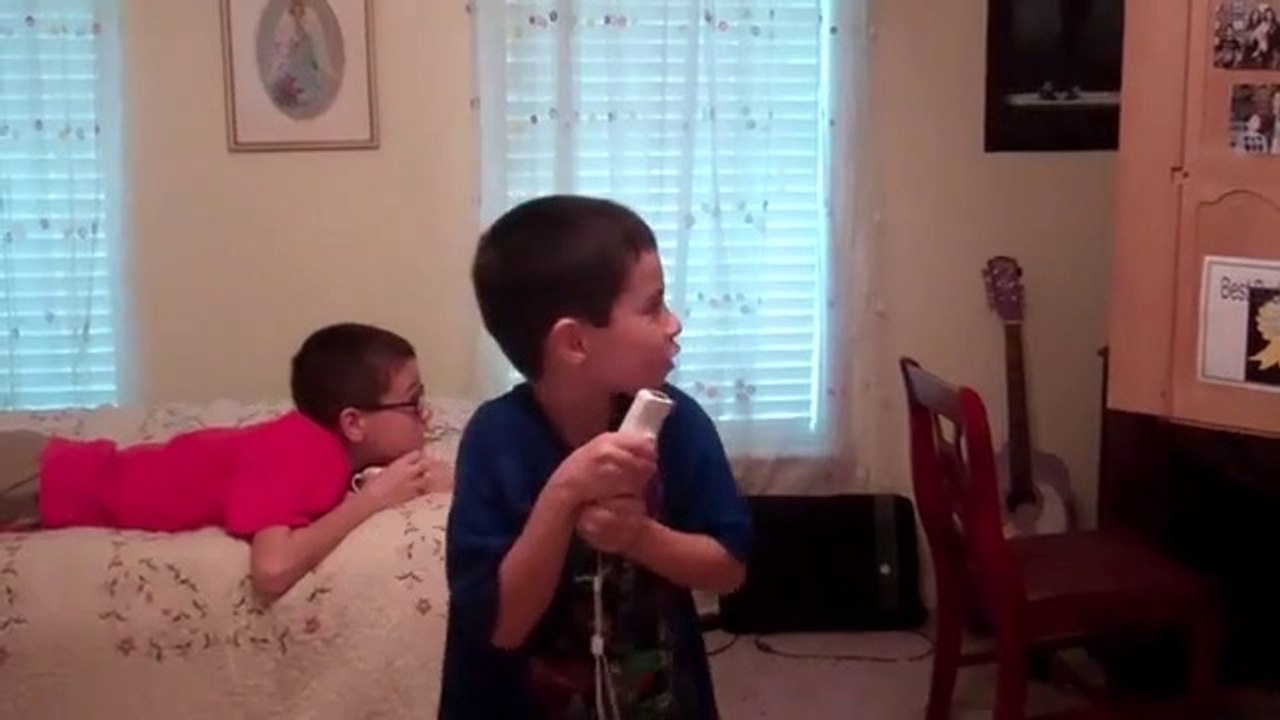 Christopher playing the wii while Jonathan & Anthony watch