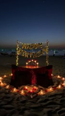 A Birthday Celebration Set-up On The Sand Of A Beach Shore