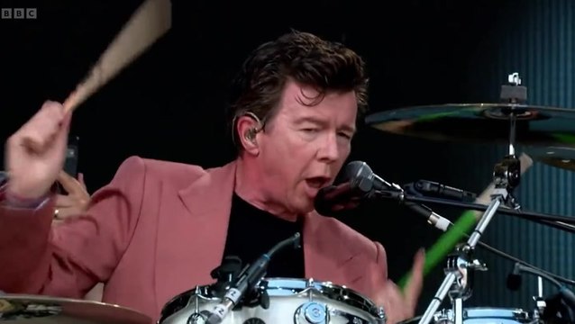 Rick Astley covers AC/DC’s ‘Highway to Hell’ on drums during impressive Glastonbury set
