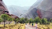 Waterfalls run down Uluru after unseasonal rain