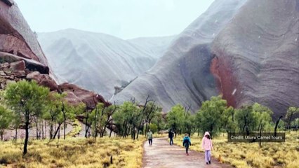 Waterfalls run down Uluru after unseasonal rain