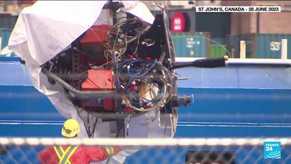 Presumed human remains and shattered Titanic submersible returned to shore