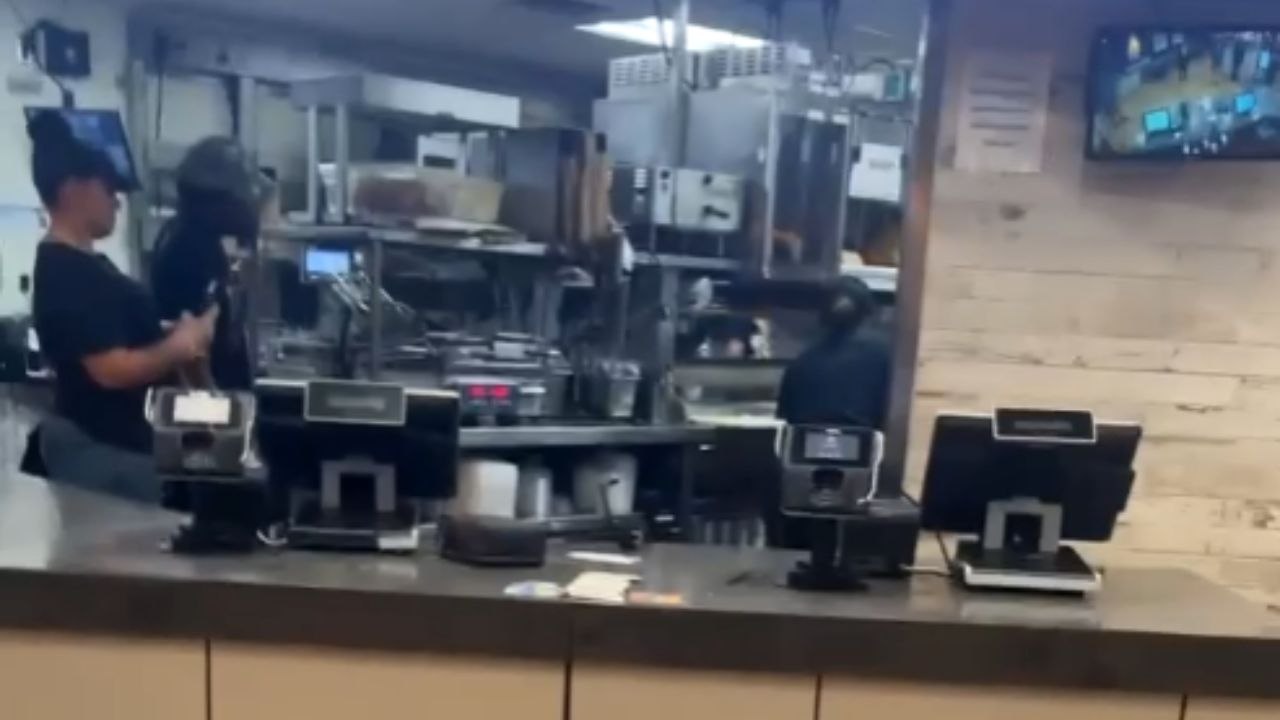 Restaurant employees serve one another with a hot hair-pulling fight