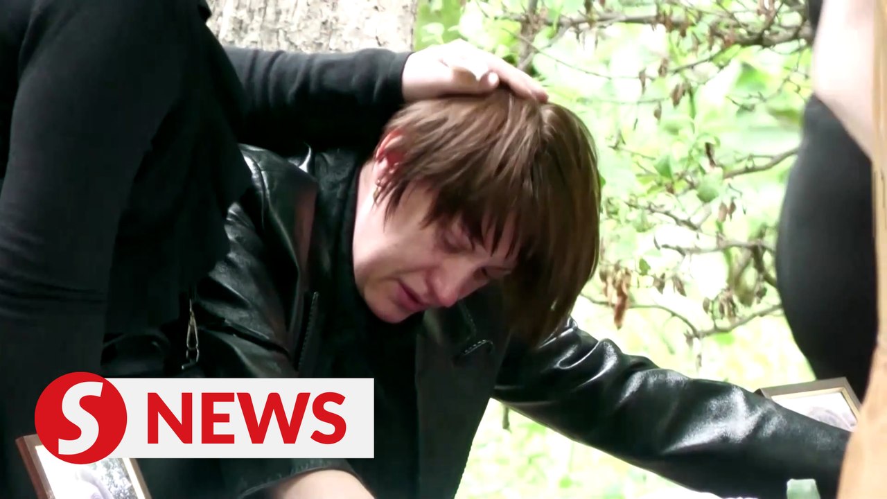 A devastated mother bids farewell to twin daugh...