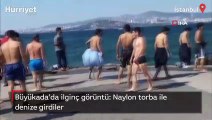 Büyükada'da ilginç görüntü: Naylon torba ile denize girdiler!