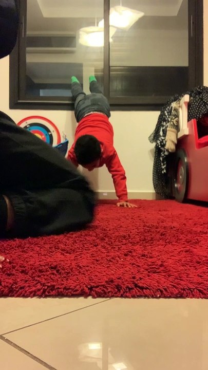 Boy punches his dad in a sensitive area as he does a handstand