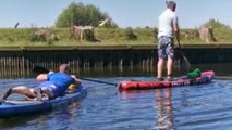 Best Friend pushes man's paddle board to throw him off of it *Harmless Prank*