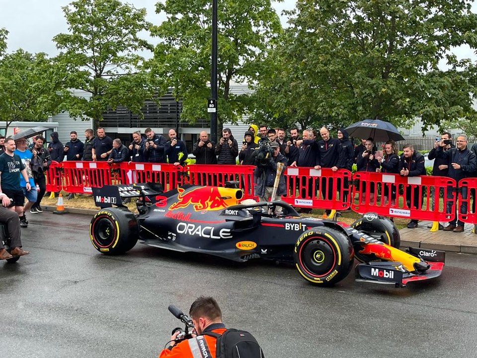 Daniel Ricciardo drives Red Bull Racing car in Milton Keynes