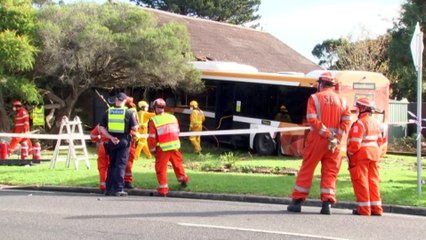 Two people in hospital after bus crashes into houses