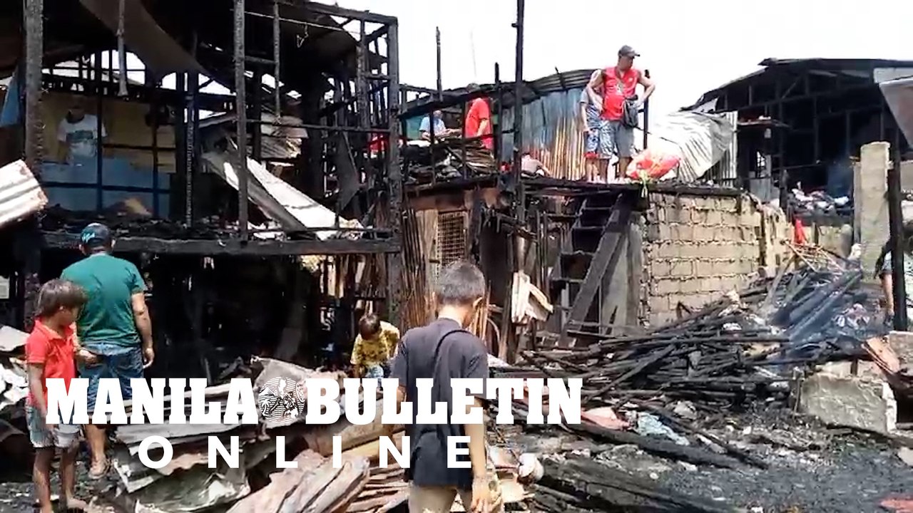 Residents search for usable items after a fire...