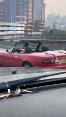 Convertible Driver Wears Respirator Mask