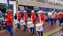A heavy shower doesn't dampen enthusiasm during the Belfast Parade