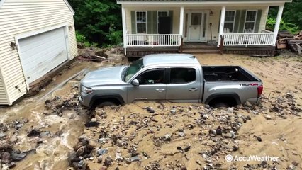 Truck buried in debris after flash floods