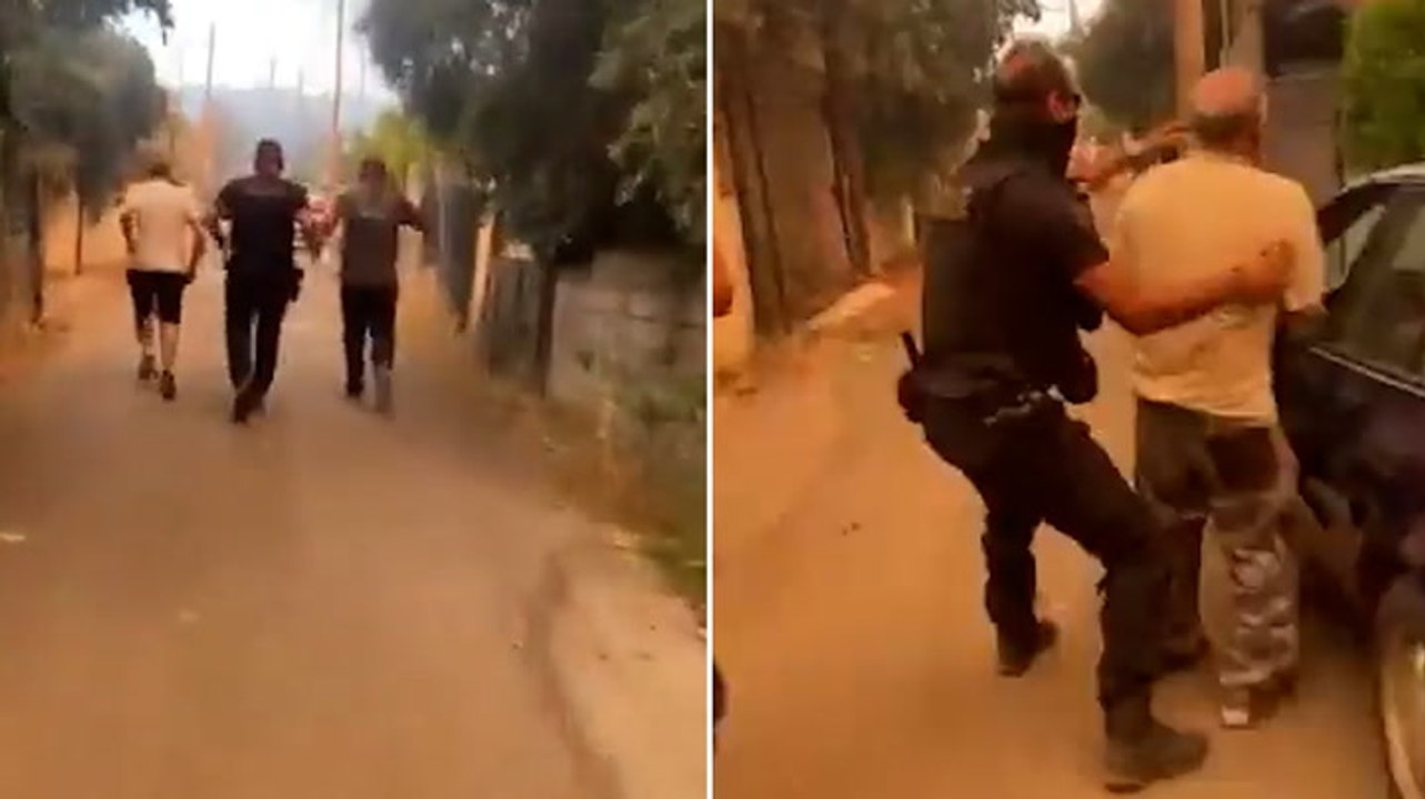 Police officers evacuate Greek residents from raging wildfires