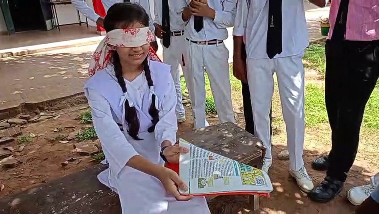 She reads the book blindfolded, tells the color of any object